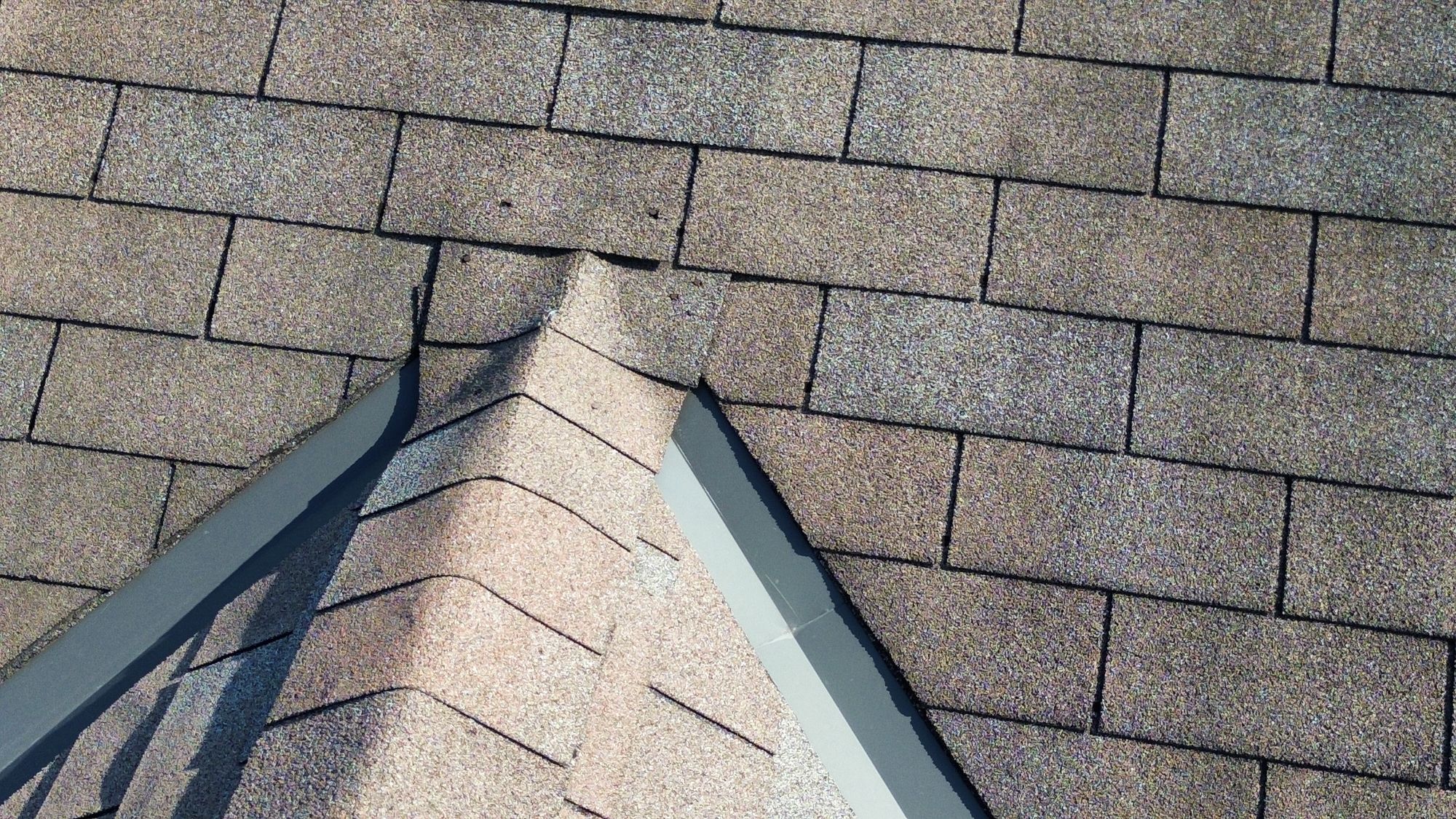 Previous shingle repair and exposed nails found during a Nepean, Ottawa home inspection